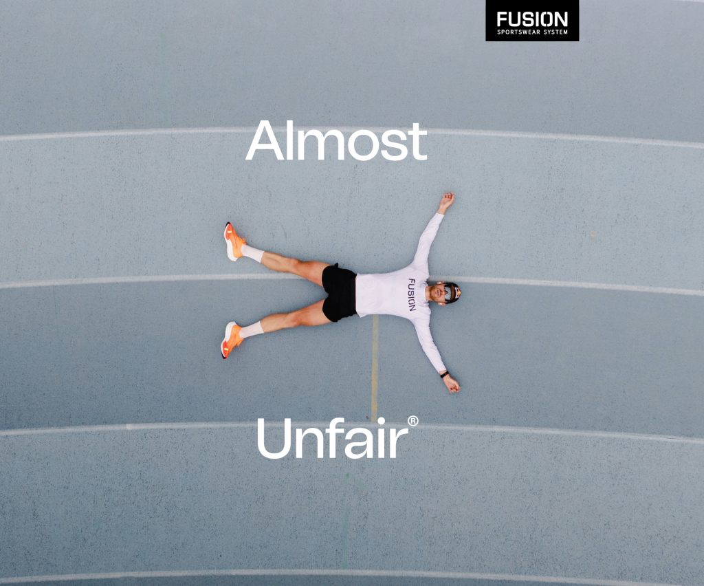Runner lying on a track under the words Almost Unfair